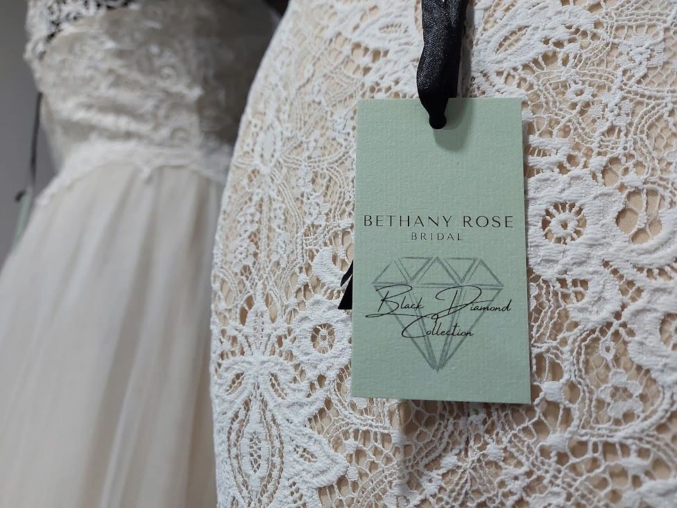 Bethany Rose Bridal label hanging from the lace of a wedding dress