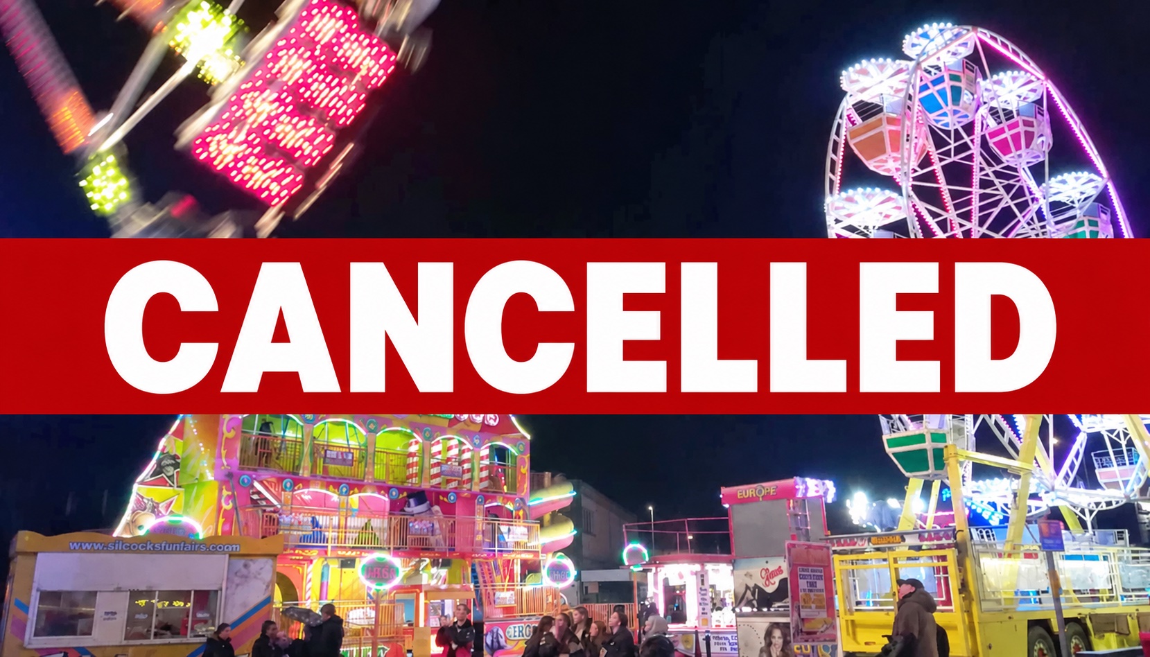 Fairground rides lit up at night with a red banner reading CANCELLED