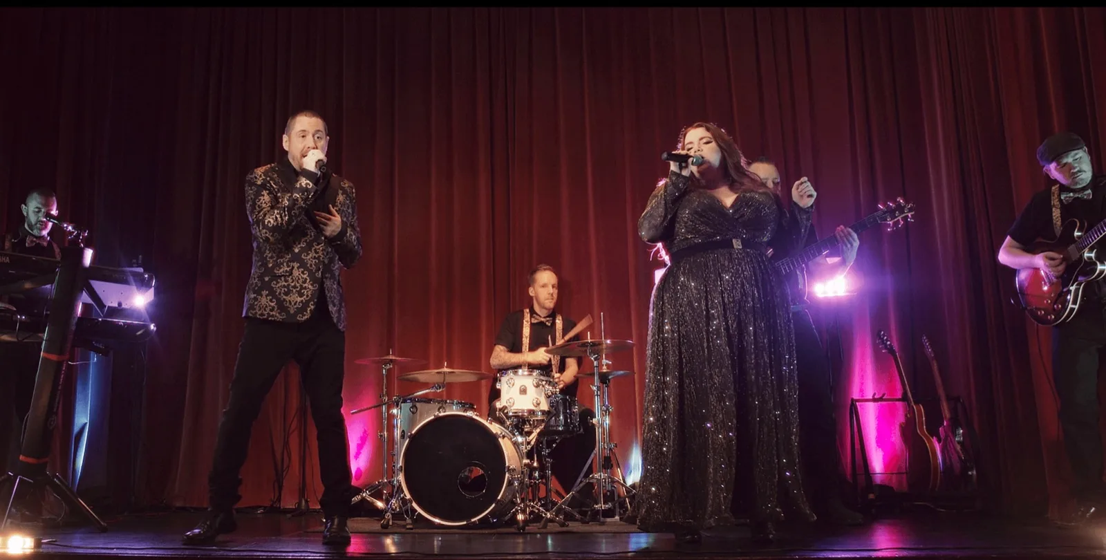 Legends of Motown singers and live band performing on stage