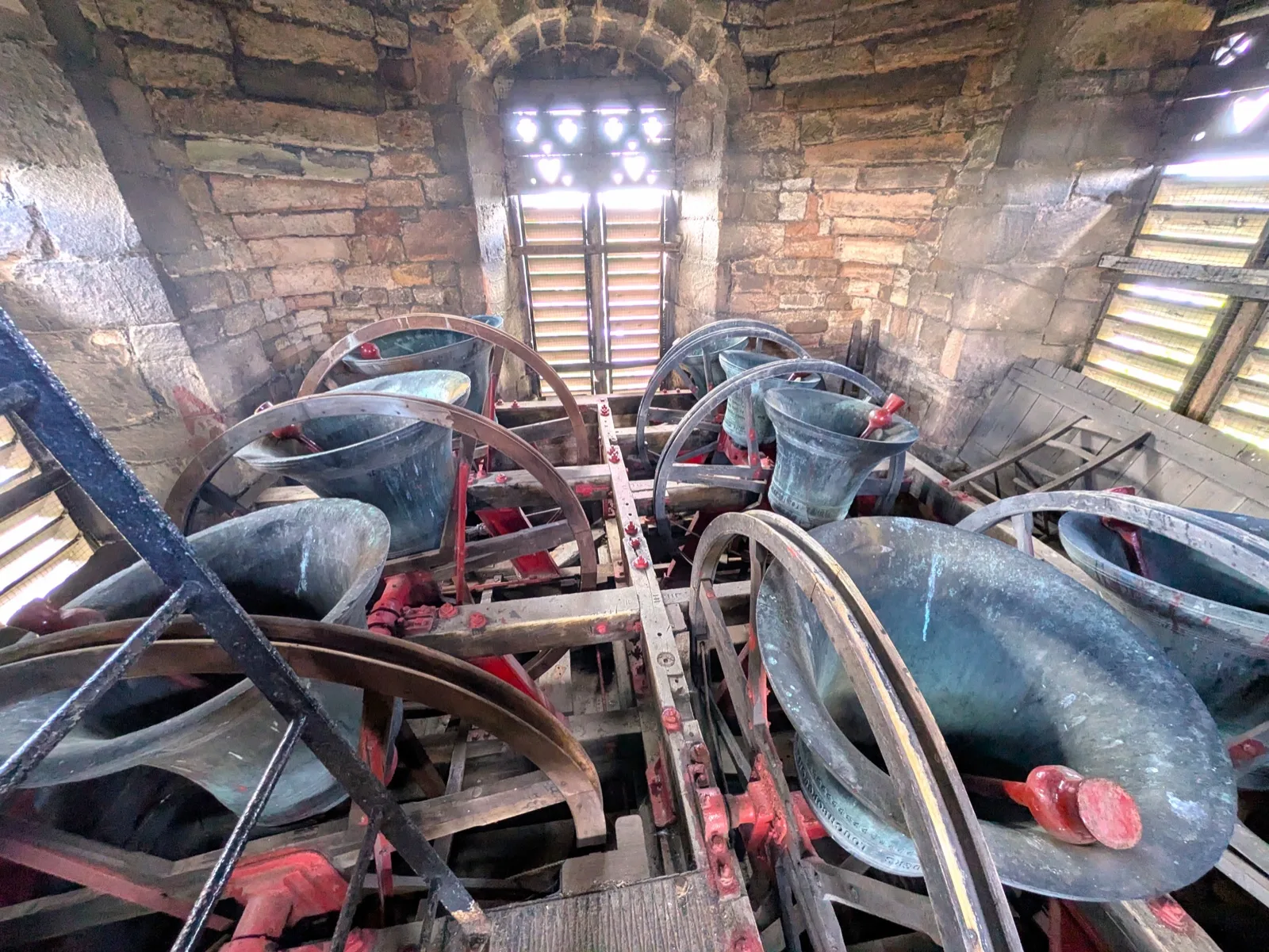 Historic bells and timber bell wheels inside the All Saints Church tower in Sawley