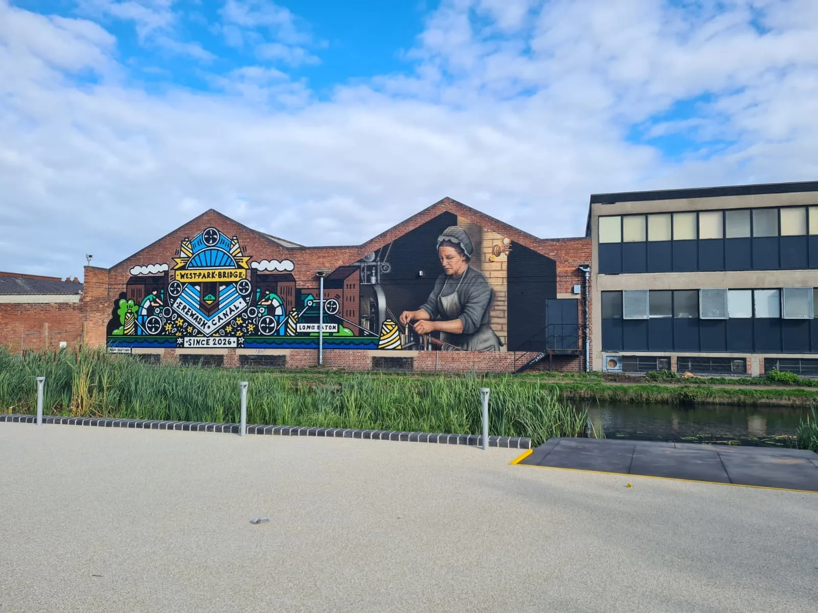 Canal-side mural depicting a lace worker and Long Eaton’s industrial history beside West Park Bridge